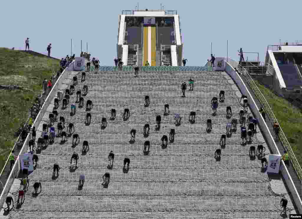 Athletes compete during the Red Bull 400 uphill sprint at the Sunkar International Ski Jumping Complex in Almaty, Kazakhstan.