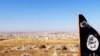 FILE - The trademark Islamic State flag is seen in the Mishtenur area, a plateau south of Kobani, Syria, Oct. 10, 2014. With IS militants losing their grip over their traditional Syrian strongholds, some say the militants may be left next year with control just of the eastern Syrian province of Deir Ezzor. 