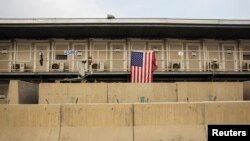 FILE - A U.S. flag hangs off of a housing unit inside of Bagram Air Base in the Parwan province of Afghanistan. NATO said a suicide blast has killed six of its soldiers and wounded three others near Bagram airbase, Dec. 21, 2015.