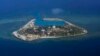 FILE - The Vietnamese-claimed Southwest Cay island in the Spratly island group is seen from a Philippine Air Force C-130 transport plane during the visit to the Philippine-claimed Thitu Island by Defense Secretary Delfin Lorenzana, Armed Forces Chief Gen.