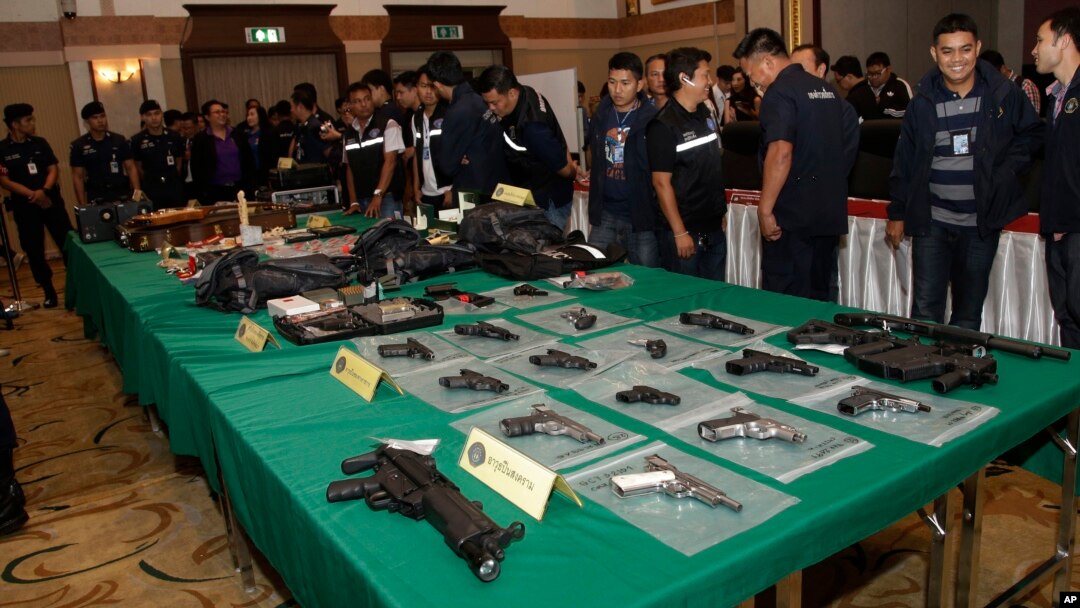 FILE - Thai police officials display seized guns before a press conference in Bangkok, Thailand, Oct. 28, 2015.