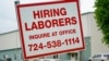 FILE - A sign seeking to hire laborers is posted outside a concrete products company in Evans City, Pennsylvania, May 5, 2021. 