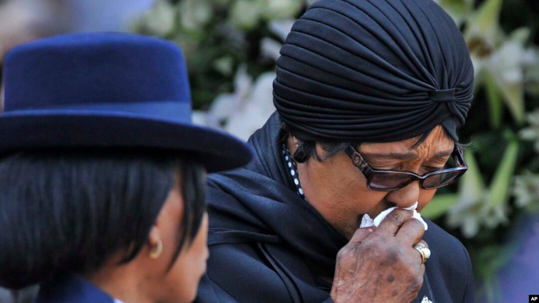 FILE - Winnie Madikizela-Mandela, Nelson Mandela's former wife, walks away after paying her respect to former South African President Nelson Mandela during the lying in state at the Union Buildings in Pretoria, South Africa, Dec. 11, 2013.