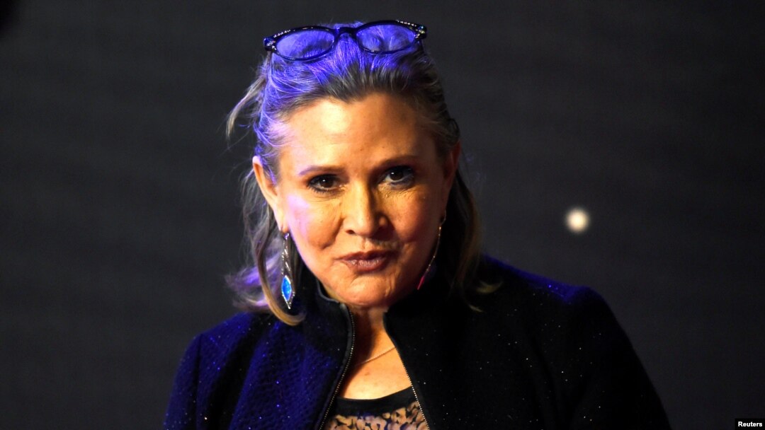 FILE - Carrie Fisher poses for cameras as she arrives at the European Premiere of "Star Wars, The Force Awakens" in Leicester Square, London, Dec. 16, 2015. 
