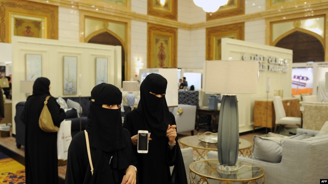 FILE - Saudi women wear the mandatory abaya, or loose-fitting gown, over their clothes in Jeddah, Saudi Arabia, Nov. 8, 2017. Rumors are circulating that a mixed-gender nightclub that does not require women to wear loose robes has opened in the city.