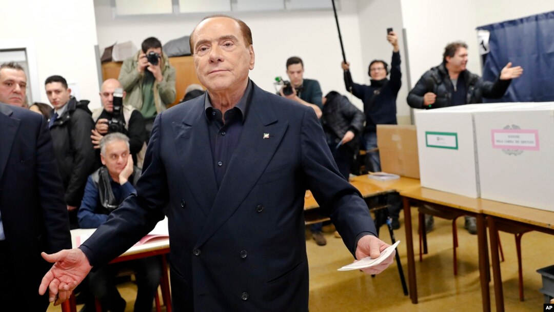 Italian former premier and leader of Forza Italia (Let's Go Italy) party Silvio Berlusconi listens to reporters at a polling station in Milan, Italy, Sunday, March 4, 2018.