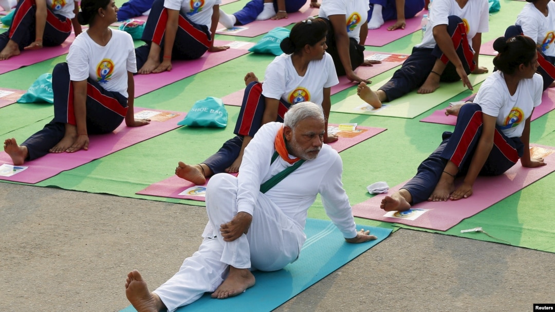 FILE - India's Prime Minister Narendra Modi participates in a yoga session to mark International Day of Yoga, in New Delhi, India, June 21, 2015. In an effort to promote India's traditions abroad, two yoga teachers from India will hold daily classes at the upcoming World Economic Forum at Davos.
