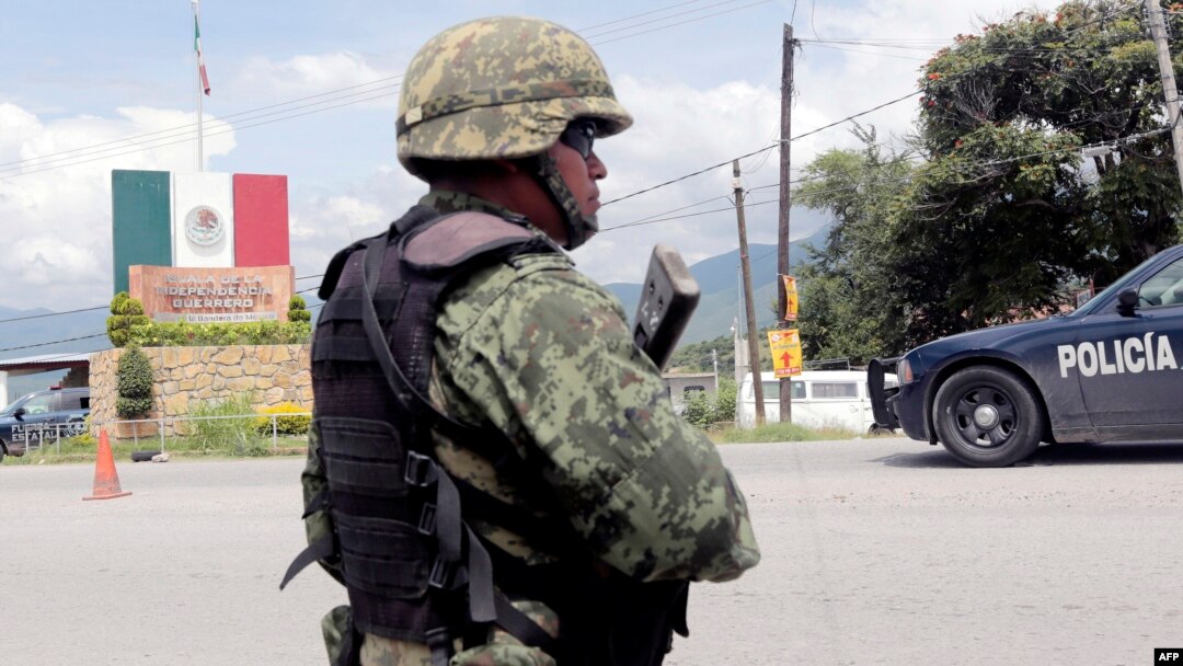 A Mexican soldier stands guard at a checkpoint in Iguala, Guerrero State, Mexico, Sept. 29, 2014, following recent clashes that led to at least six deaths.
