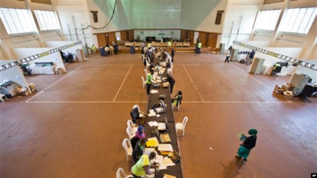 FILE - Electoral workers engage in vote tally verification process at National Tallying Center in Nairobi, Kenya March 6, 2013