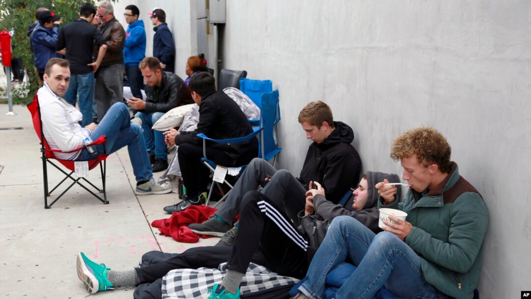People wait in line after spending the night for the new Apple watch at Maxfield, a high-end fashion boutique in Los Angeles, April 24, 2015.