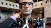 An engineer makes an adjustment to the robot "The Incredible Bionic Man" at the Smithsonian National Air and Space Museum in Washington, Oct. 17, 2013.