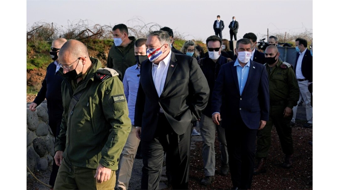 U.S. Secretary of State Mike Pompeo is accompanied by Israeli Foreign Minister Gabi Ashkenazi as they arrive for a security briefing on Mount Bental in the Israeli-occupied Golan Heights, Nov. 19, 2020.