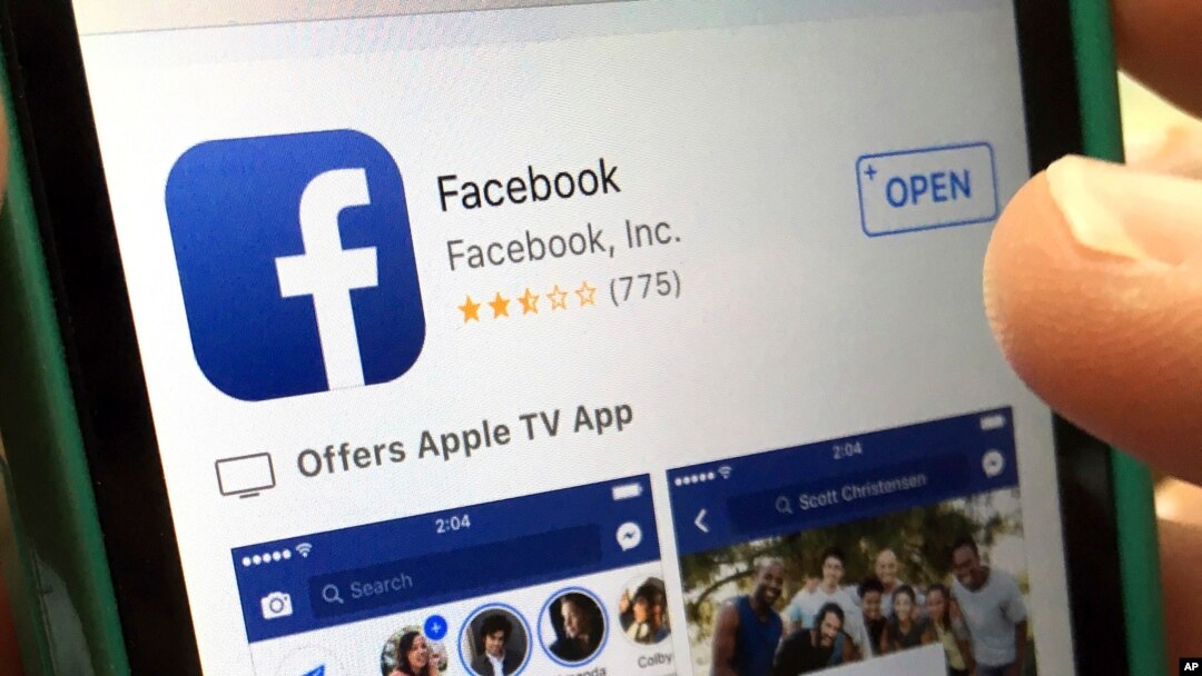 FILE - A user gets ready to launch Facebook on an iPhone, in North Andover, Mass., June 19, 2017. Facebook has made changes to fight false information, including de-emphasizing proven false stories in people's feeds so others are less likely to see them. 