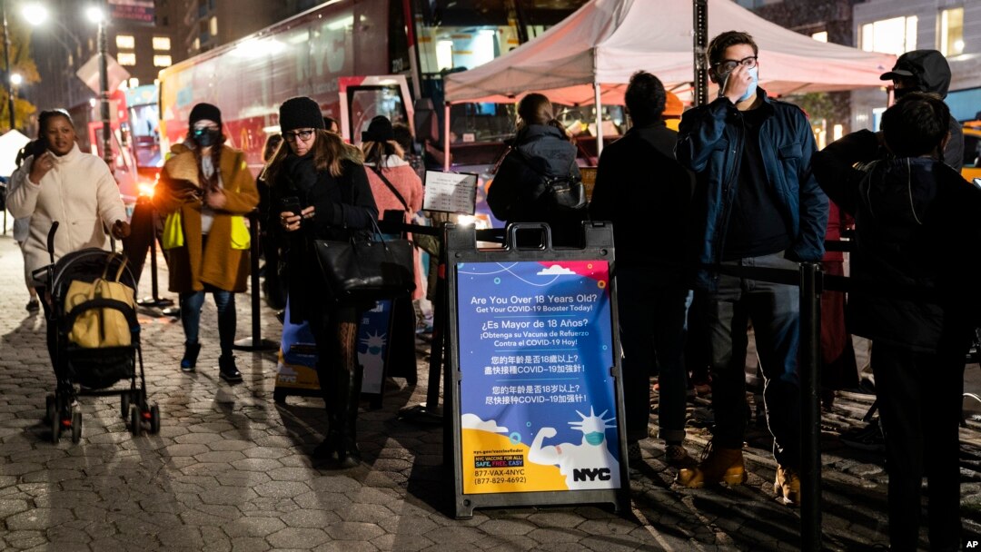 FILE - People wait to receive a COVID-19 vaccine booster shot at a mobile vaccination site near Central Park in New York City, Dec. 2, 2021. 