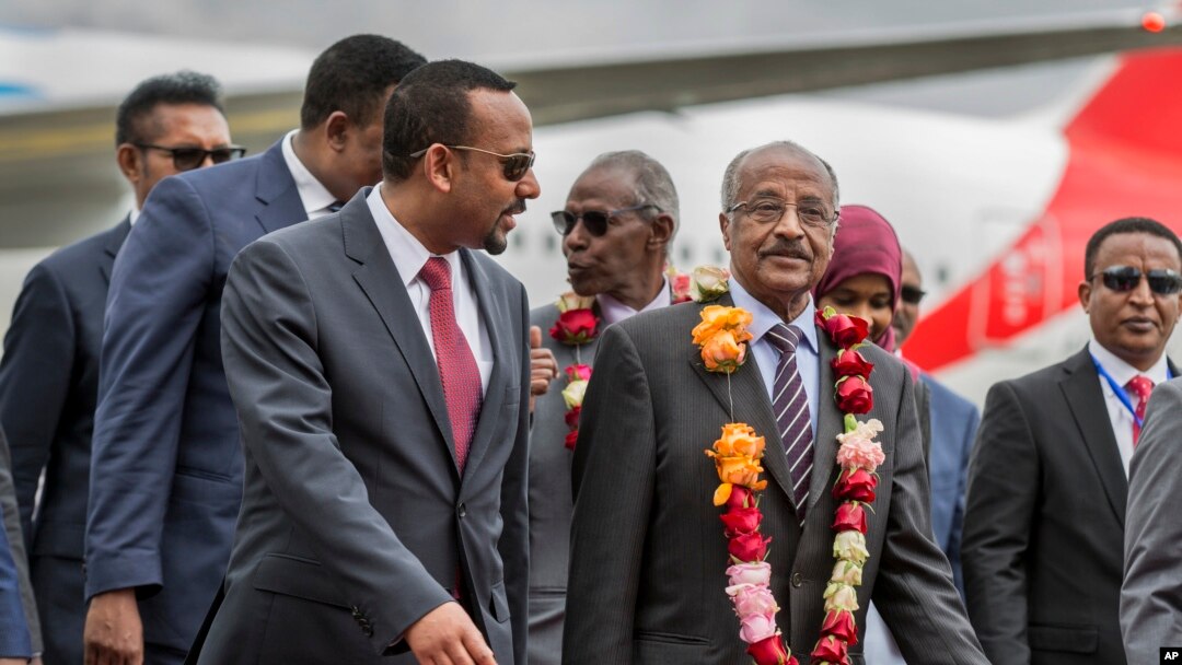 FILE - Eritrea's Foreign Minister Osman Sale, center-right, is welcomed by Ethiopia's Prime Minister Abiy Ahmed, center-left, upon the Eritrean delegation's arrival at the airport in Addis Ababa, Ethiopia, June 26, 2018.
