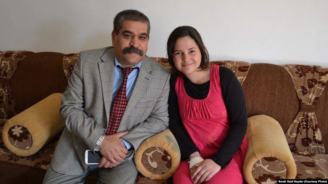 FILE - Sarah Said Haydar, 16, with her father before her capture by Islamic State militants last August. 