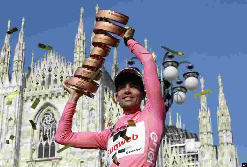Tom Dumoulin of the Netherlands holds up the trophy after winning the Giro d'Italia, Tour of Italy cycling race, in Milan.