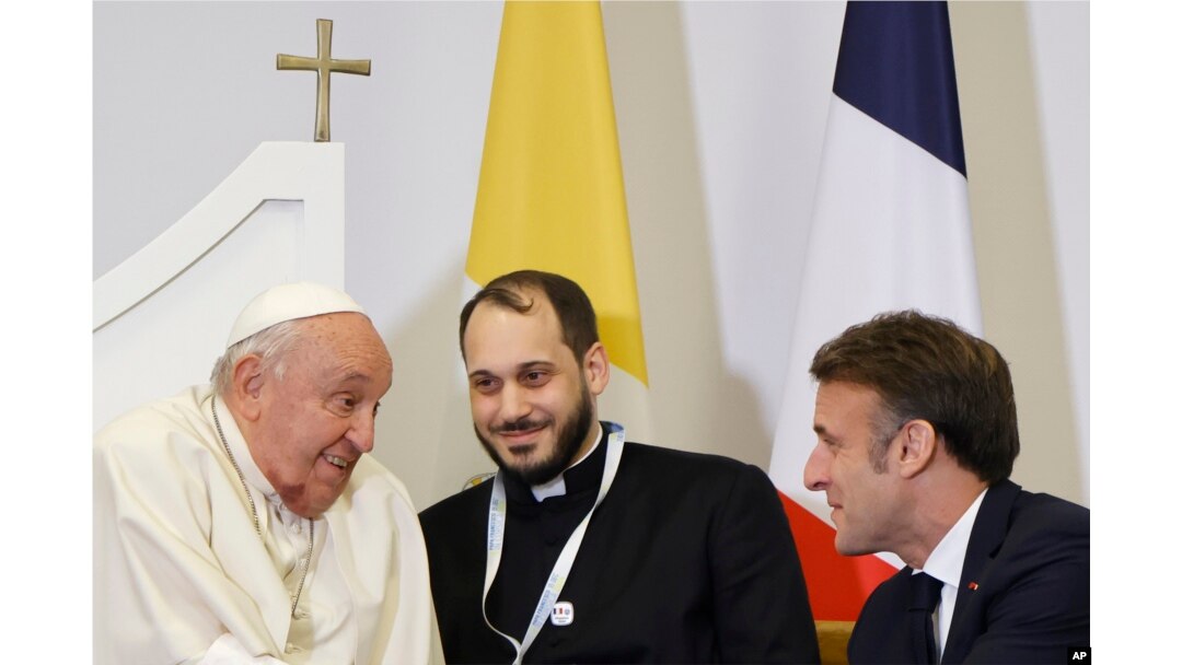 French President Emmanuel Macron, right, meets Pope Francis at the Ajaccio airport after the first papal visit ever to the French island of Corsica, Dec. 15, 2024.