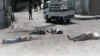 This citizen journalist image provided by The Syrian Revolution against Bashar Assad, which has been authenticated based on its contents and other AP reporting, shows Syrian army soldiers standing in front of dead bodies at Bayda village.
