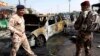 Iraqi security force members gather at the site of a car bomb attack in front of a crowded popular restaurant in Basra, southeast of Baghdad, Iraq, May 20, 2013.