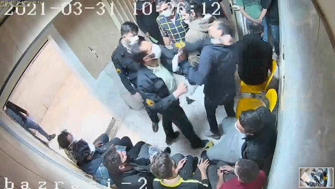 In this frame grab taken from video shared with AP by 'The Justice of Ali,' a guard beats a prisoner, at Evin prison in Tehran, Iran. (The Justice of Ali via AP)