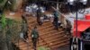 Kenya Defense Forces soldiers move at the main entrance of Westgate shopping centre, on the fourth day since militants stormed into the mall, in Nairobi, Sept. 24, 2013. 