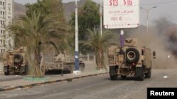 Military vehicles of the Southern Resistance fighters move during clashes with Houthi fighters on a street in Yemen's southern port city of Aden, July 17, 2015.