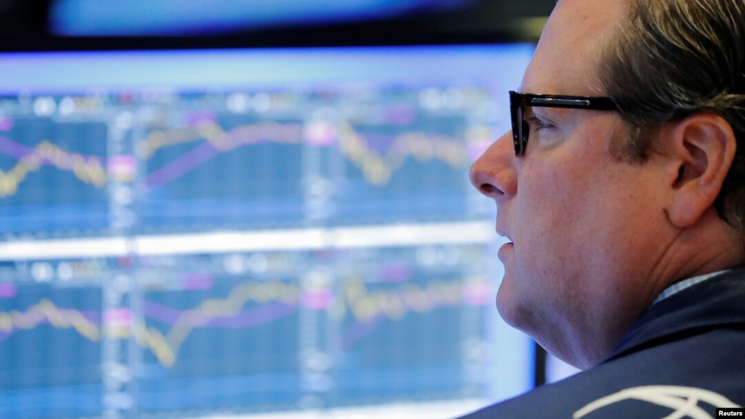 FILE - A trader works on the floor of the New York Stock Exchange shortly after the opening bell in New York, July 31, 2018. 