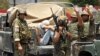 Lebanese army soldiers gesture as they capture a gunman in Sidon, southern Lebanon, June 24, 2013.