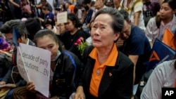 A supporter of Thailand's Future Forward Party cries as she watches a live television broadcast of a court verdict at the party's headquarters in Bangkok, Thailand, Feb. 21, 2020. 
